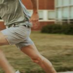 Close-up of a person sprinting outdoors, representing cardio exercise before strength training