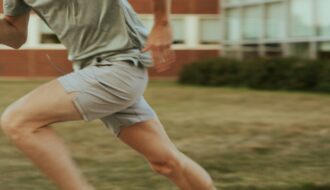 Close-up of a person sprinting outdoors, representing cardio exercise before strength training