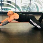 Man performing an ab roller exercise, demonstrating core strength and fitness for gaining muscle after 40