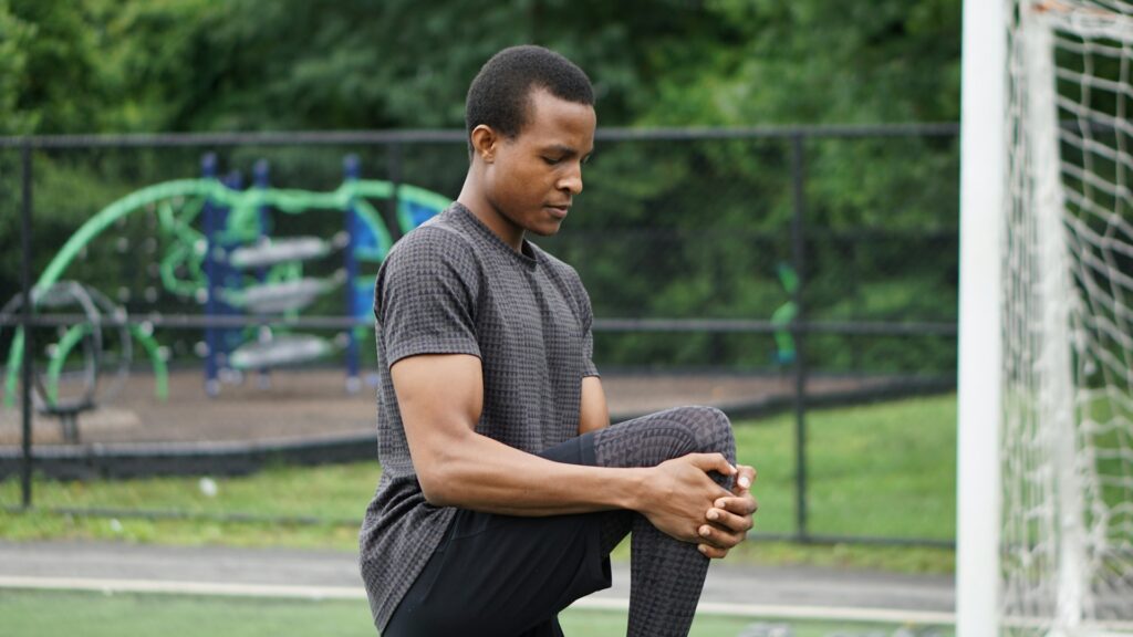 an stretching before a workout, emphasizing the importance of warm-ups for gaining muscle after 40.